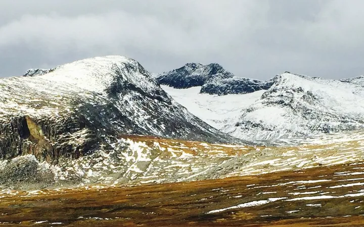 Sylarna: snow-dusted peaks above autumn-gold moorland